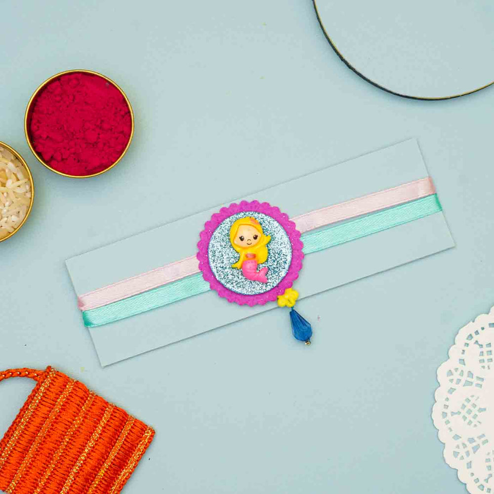 Personalized Handmade Mermaid Theme Felt Kids Rakhi And Name Plate Combo For Sisters Set Of 2 - Flat Lay on Decorative Background
