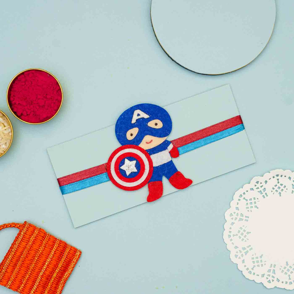 Personalized Handmade Superhero Theme Felt Kids Rakhi And Name Plate Combo For Brother Set Of 2 - Flat Lay Rakhi Packaging Display