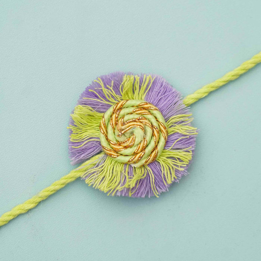 Handmade Macrame Purple And Green Cotton Rakhi With Chocolates And Roli Chawal - Close-up of decorative centerpiece