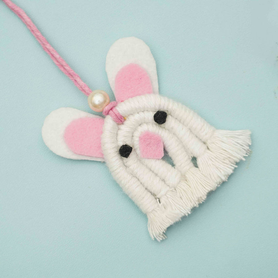 Handmade Macrame White Bunny Design Cotton Kids Rakhi For Girls With Chocolates And Roli Chawal - Close-up Front View
