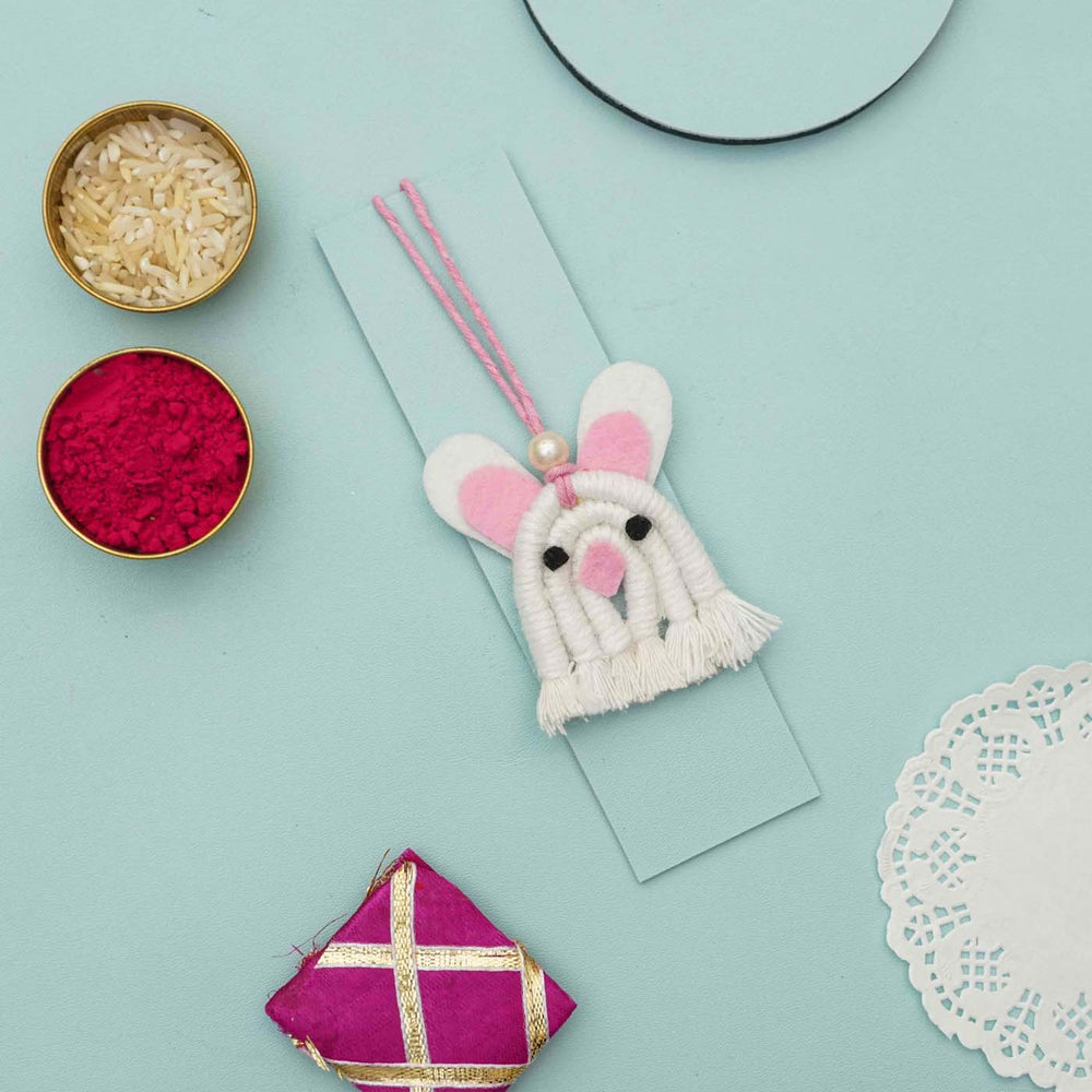 Handmade Macrame White Bunny Design Cotton Kids Rakhi For Girls With Chocolates And Roli Chawal - Mounted on Festival Cardboard