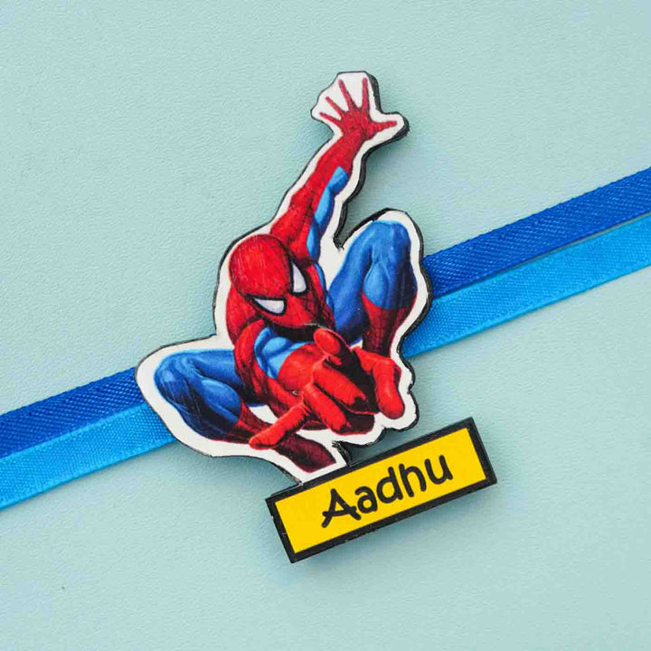 Personalized Reusable X Large Spiderman Name Mdf Wood Rakhi With Chocolates And Roli Chawal - Close-up of personalized character charm