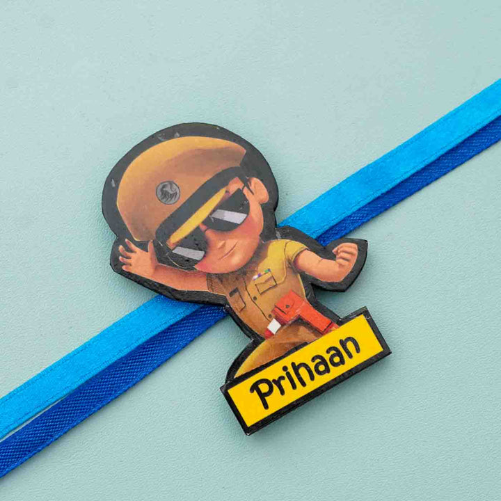 Personalized Reusable X Large Little Singam Mdf Wood Rakhi With Chocolates And Roli Chawal - Close-up of Character Badge