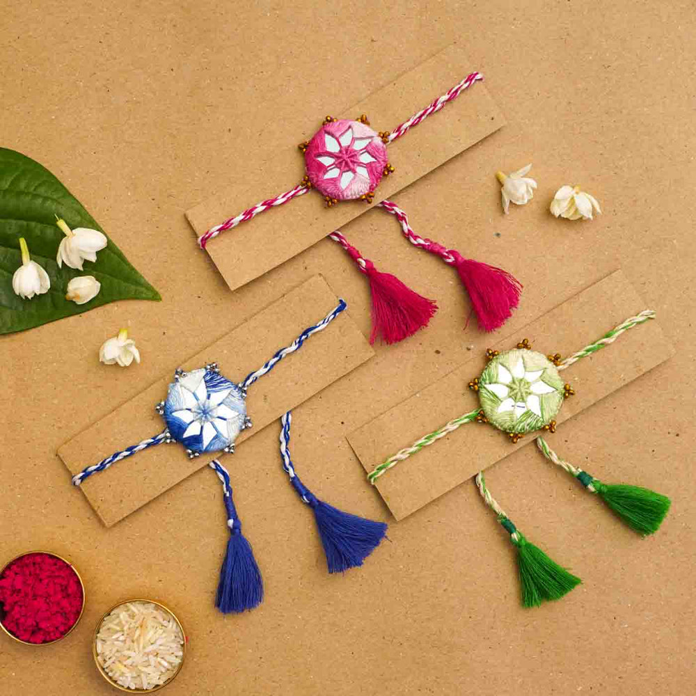Handmade Mirror Work Kaanha Assorted Colours Cotton Rakhi With Roli Chawal Set Of 3 - Bracelets displayed on cards