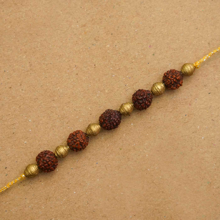 Handmade Ecofriendly Rudraksh Recycled Paper Rakhi With Roli Chawal - Close-up of string beads bracelet