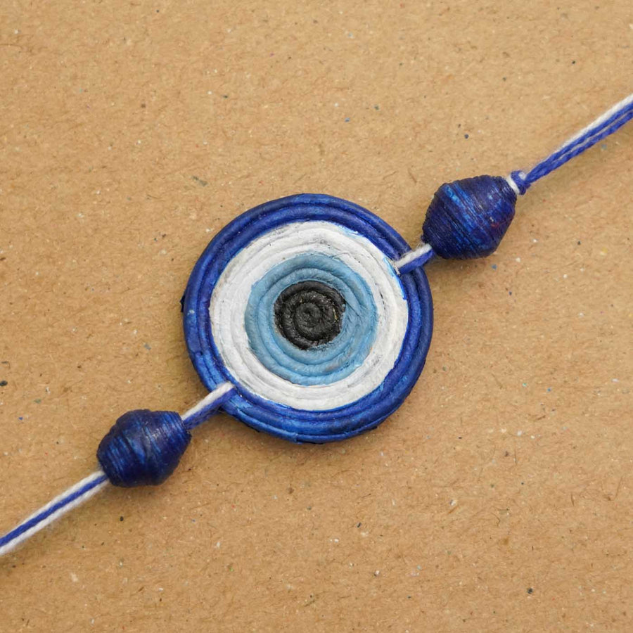 Handmade Ecofriendly Evil Eye Recycled Paper Rakhi With Roli Chawal - Close-up of bracelet detail