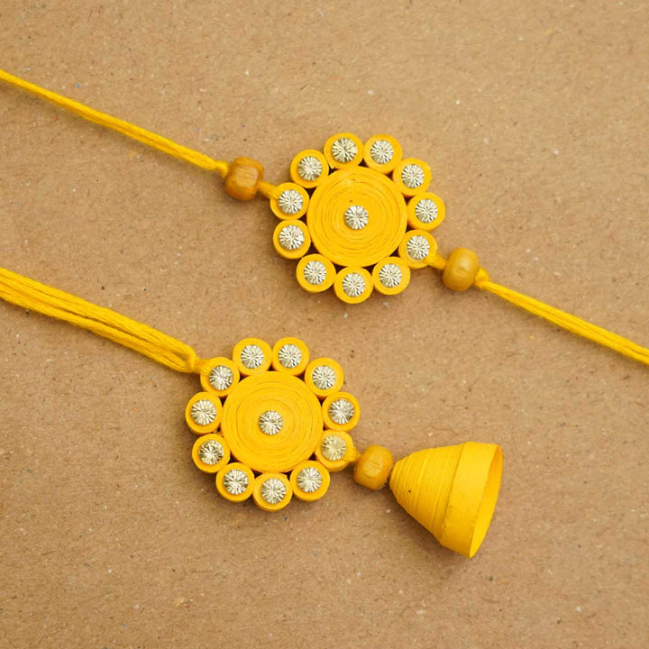 Handmade Ecofriendly Yellow Quilled Recycled Paper Bhaiya Bhabhi Rakhi With Roli Chawal - Flat lay close-up view