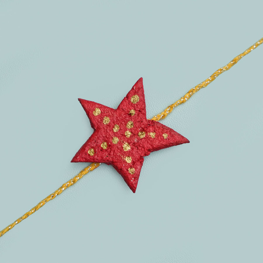 Handmade Ecofriendly Star Recycled Paper Rakhi With Roli Chawal - Close-up of Star Charm on Thread