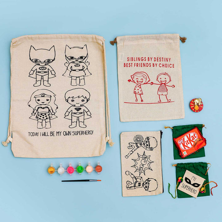 Eco Friendly Fabric Painting Diy Rakhi Hamper With Rice Roli 2 - Flat Lay Superhero Set Items