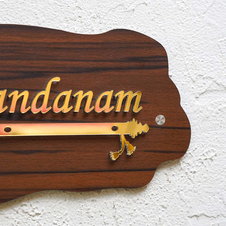 Personalized Weatherproof Golden Flute Acrylic Name Plate - Mounted on Textured Wall Close-up