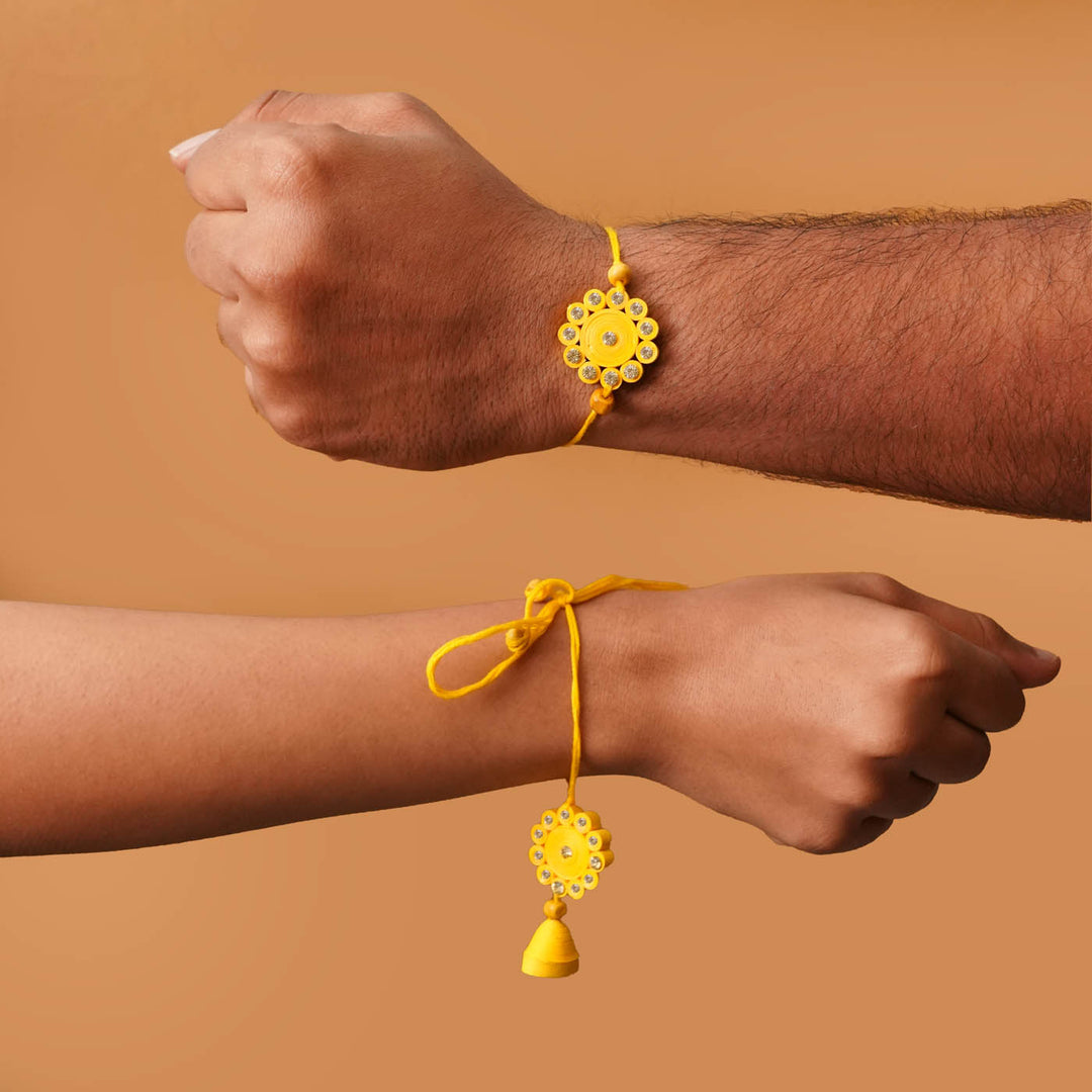 Handmade Ecofriendly Yellow Quilled Recycled Paper Bhaiya Bhabhi Rakhi With Roli Chawal - Worn on wrists close-up