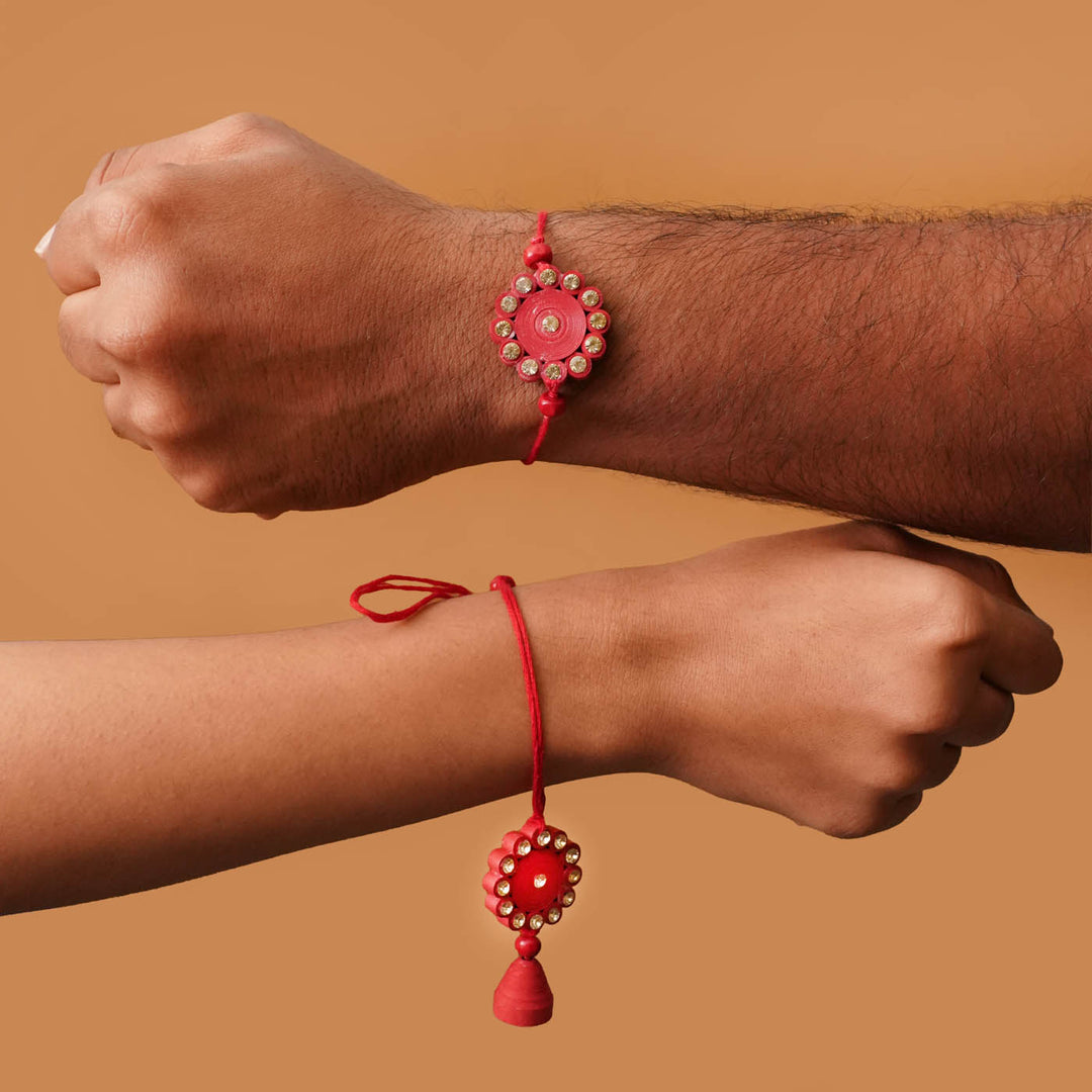 Handmade Ecofriendly Red Quilled Recycled Paper Bhaiya Bhabhi Rakhi With Roli Chawal - Worn on wrist by two models