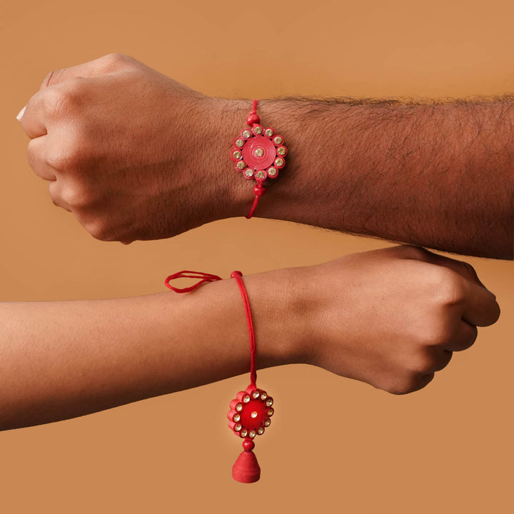 Handmade Ecofriendly Red Quilled Recycled Paper Bhaiya Bhabhi Rakhi With Roli Chawal - Worn on wrist by two models