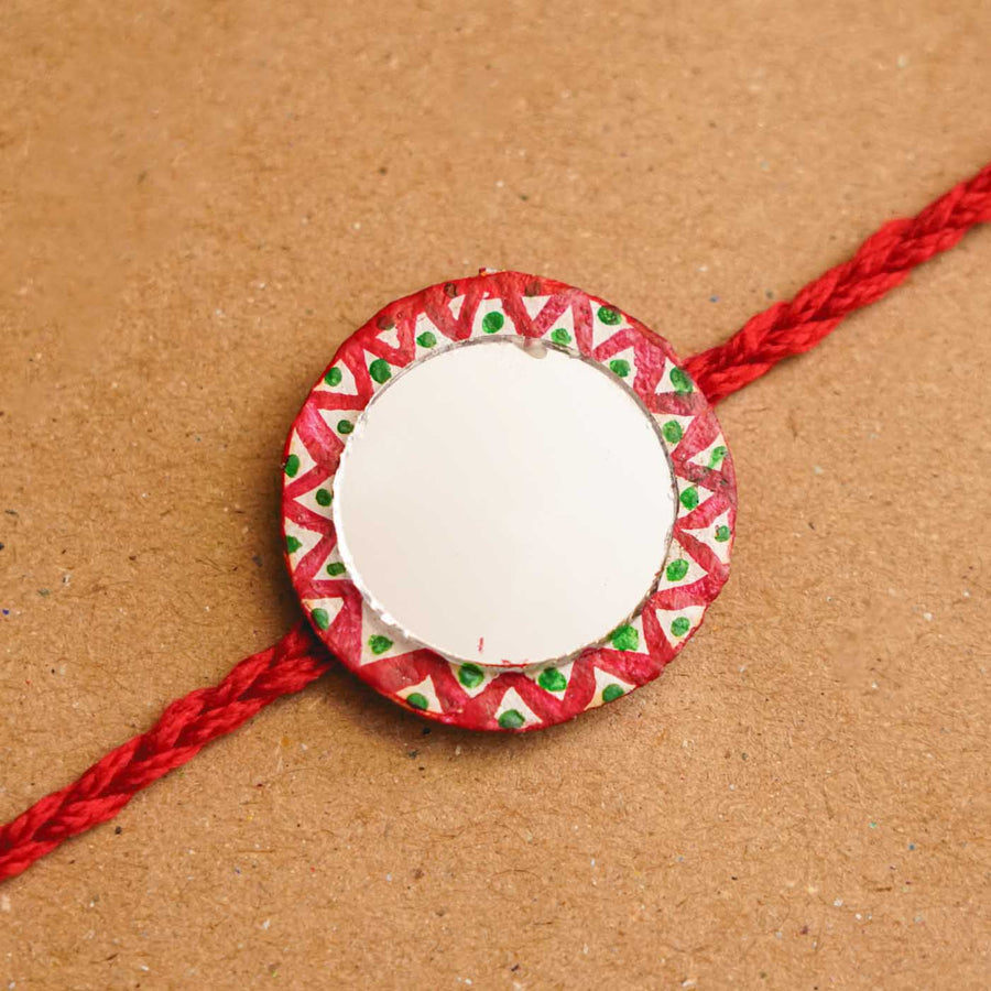 Handmade Ecofriendly Full Moon Recycled Paper Rakhi With Roli Chawal - Close-up of single bracelet face