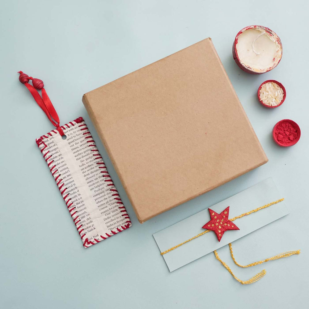 Handmade Ecofriendly Star Recycled Paper Rakhi With Roli Chawal - Flat Lay with Packaging and Accessories
