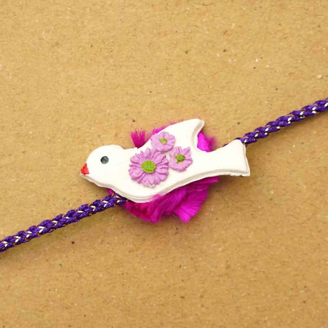 Handmade Bird Clay Rakhi With Chocolates Roli Chawal - Close-up of bird charm