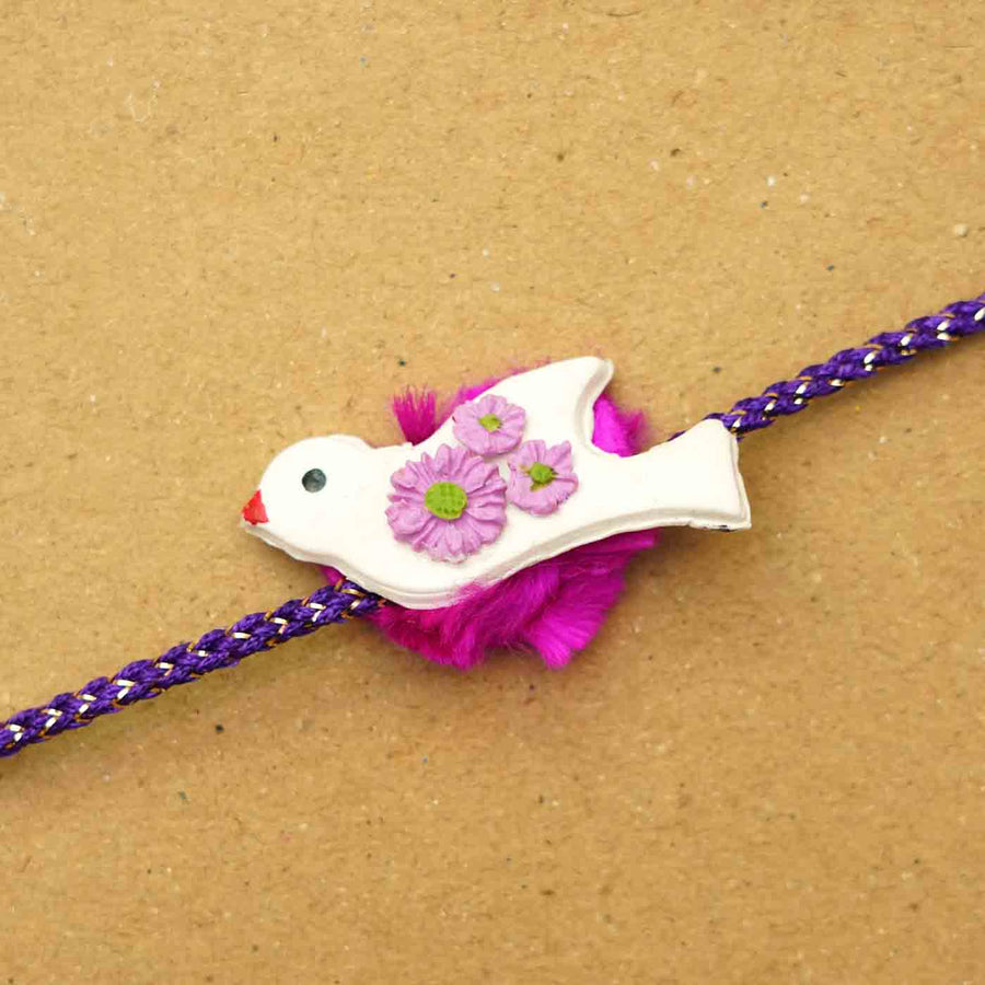 Handmade Bird Clay Rakhi With Chocolates Roli Chawal - Close-up of bird charm