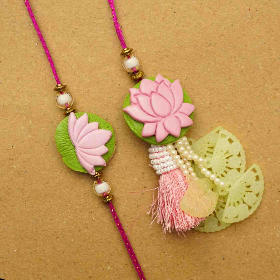 Handmade Lotus Clay Bhaiya Bhabhi Rakhi With Chocolates And Roli Chawal Set Of 2 - Close-up of two rakhis