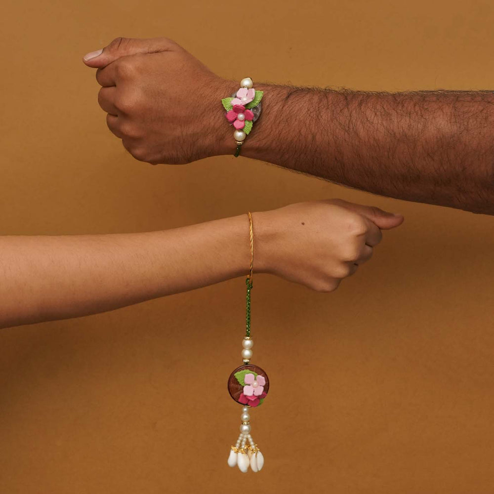 Handmade Pink Floral Clay Bhaiya Bhabhi Rakhi With Chocolates And Roli Chawal Set Of 2 - Rakhis worn on wrists