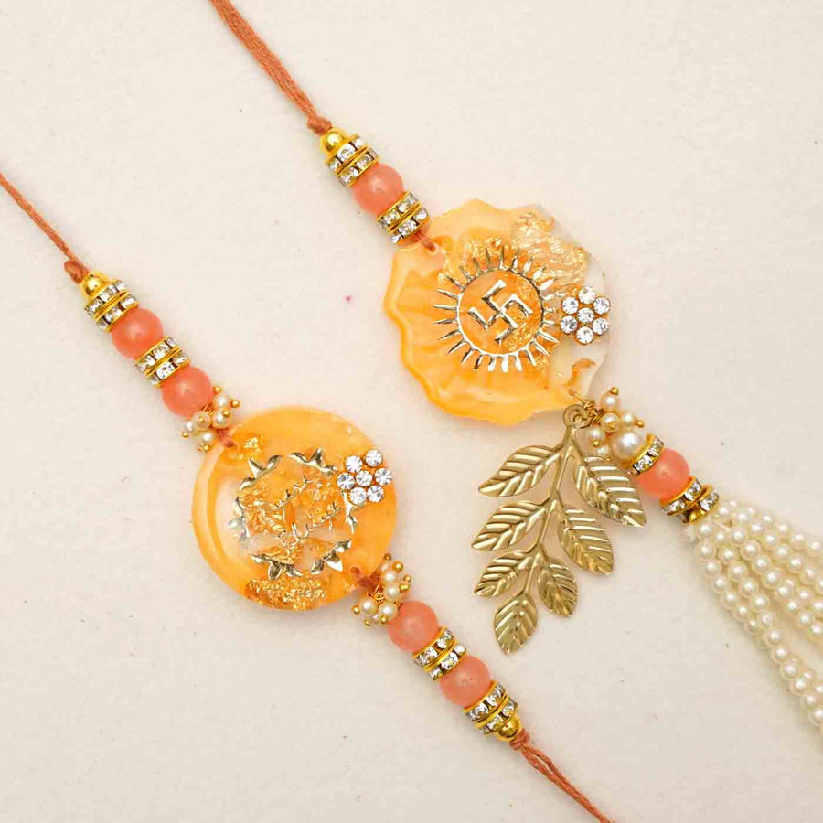 Handmade Resin Rakhi With Chocolates And Roli Chawal Set Of 2 - Close-up of two decorative rakhis