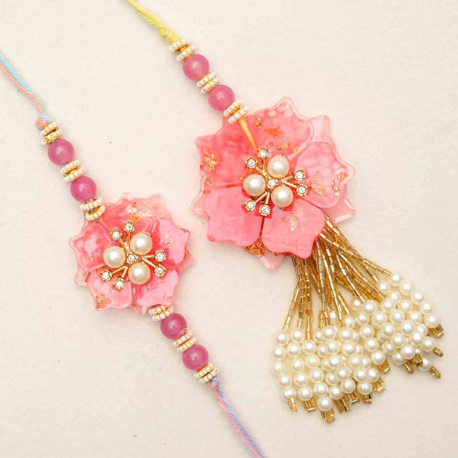 Handmade Resin Pink Flower With Pearls Bhaiya Bhabhi Rakhi With Chocolates And Roli Chawal Set Of 2 - Close-up of two rakhis