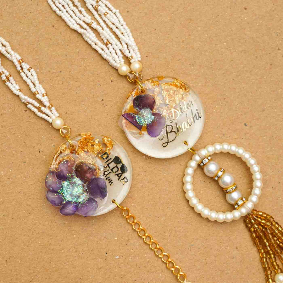 Handmade Resin Dildar Bhaiya And Dildar Bhabhi Rakhi With Chocolates And Roli Chawal Set Of 2 - Close-up Details of Two Rakhis