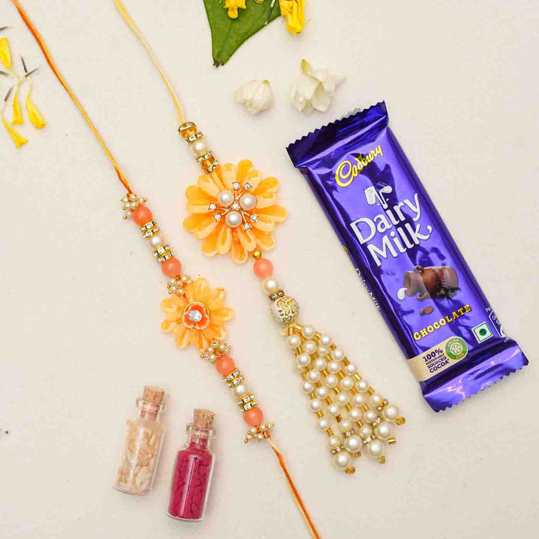 Handmade Resin Peach Flower With Pearls Bhaiya Bhabhi Rakhi With Chocolates And Roli Chawal Set Of 2 - Rakhis Shown with Gift Items