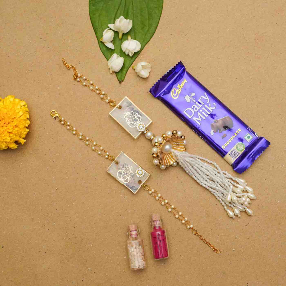 Handmade Resin Ganesha Bhaiya Bhabhi Rakhi With Chocolates And Roli Chawal Set Of 2 - Flat Lay with Decorative Items