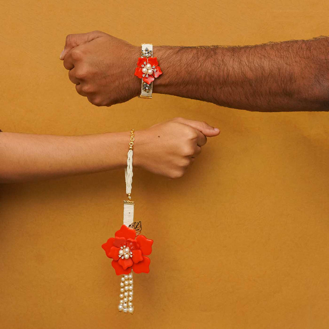 Handmade Red Flower Theme Resin Bhaiya Bhabhi Rakhi With Chocolates And Roli Chawal For Bhaiya And Bhabhi Set Of 2 - Worn on Wrist by Two People