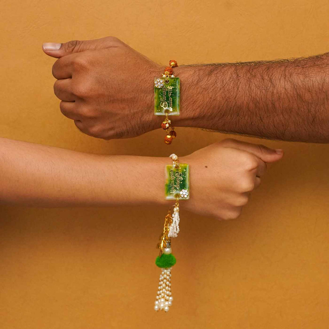 Handmade Resin Swag Wala Bhai And Swag Wali Bhabhi Rakhi With Chocolates And Roli Chawal Set Of 2 - On wrists showing size fit