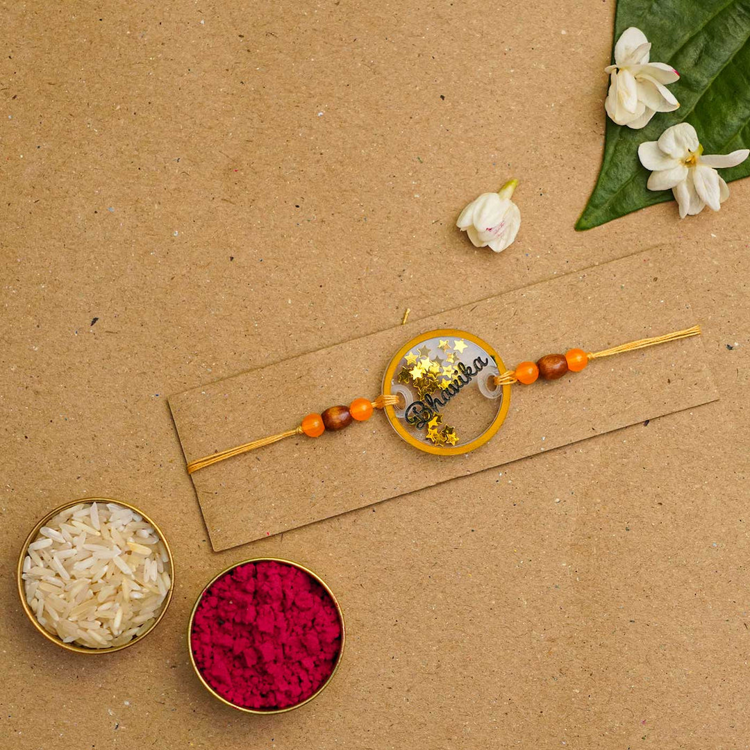 Personalized Handmade Round Glitter Acrylic Rakhi With Roli Chawal - Packaged with rice and kumkum