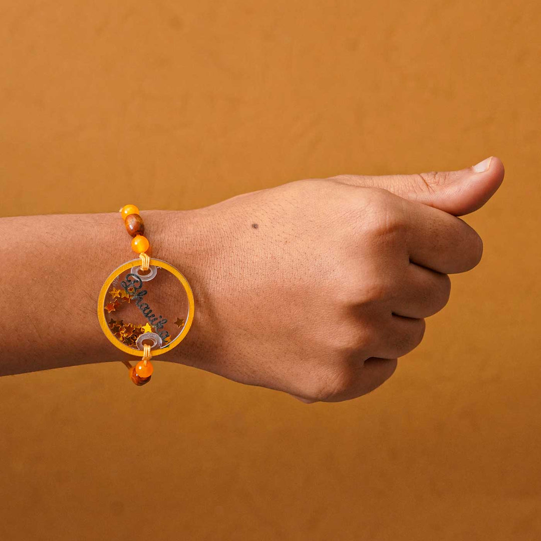 Personalized Handmade Round Glitter Acrylic Rakhi With Roli Chawal - Model wrist wearing bracelet
