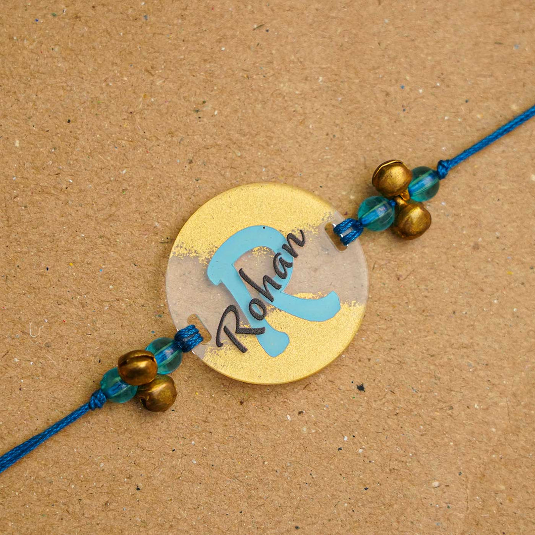 Personalized Handmade Alphabet Golden Acrylic Rakhi With Roli Chawal - Personalized Rakhi Close-up (4)
