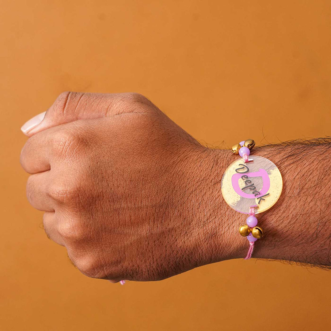 Personalized Handmade Alphabet Golden Acrylic Rakhi With Roli Chawal - Wrist Wearing Rakhi Side Angle