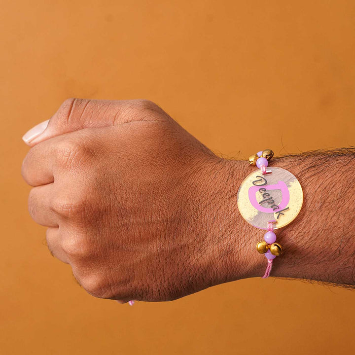 Personalized Handmade Alphabet Golden Acrylic Rakhi With Roli Chawal - Wrist Wearing Rakhi Side Angle