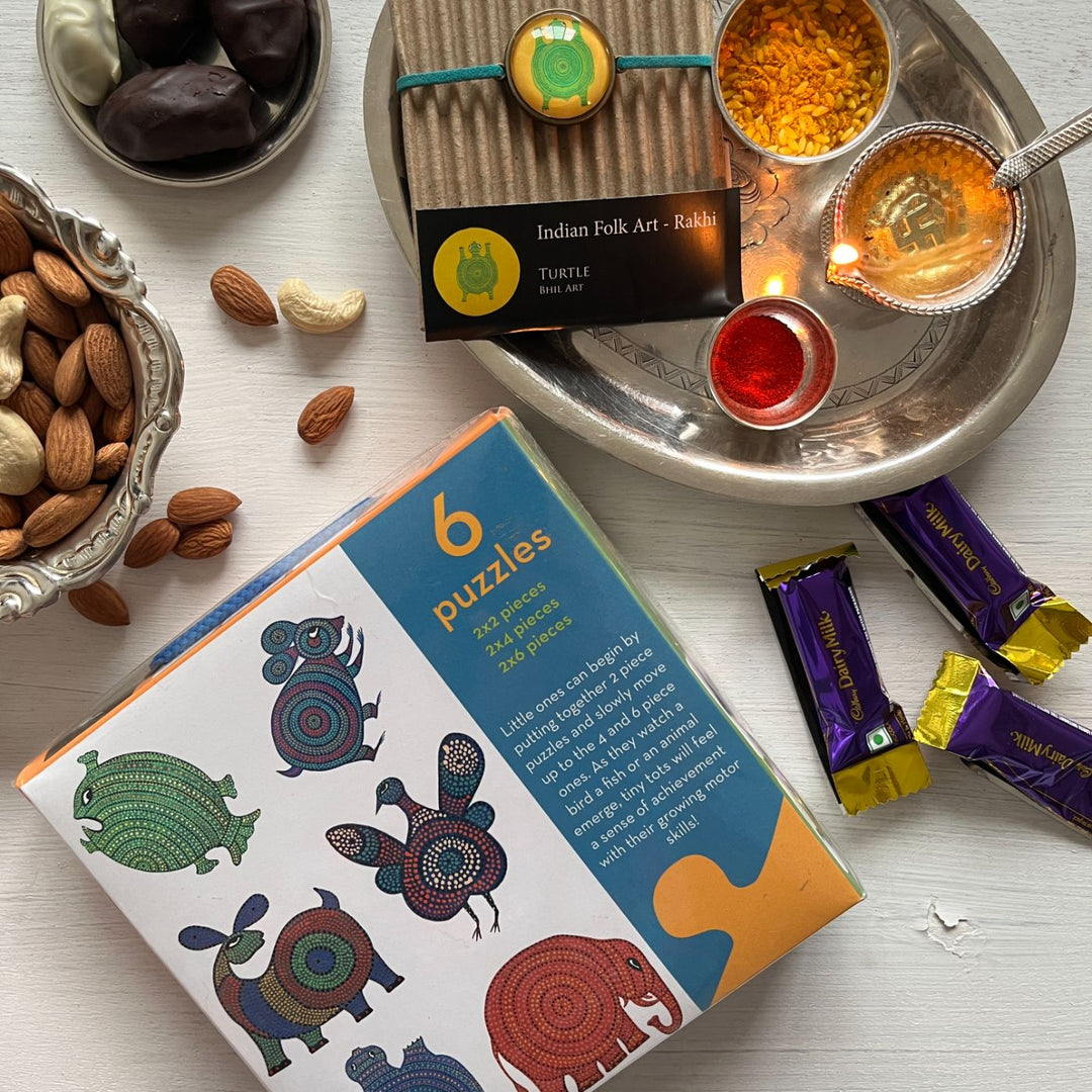 Handcrafted Folk Art Rakhi Hamper For Toddlers With Rice Roli Haldi 2 - Product and accessories flat lay