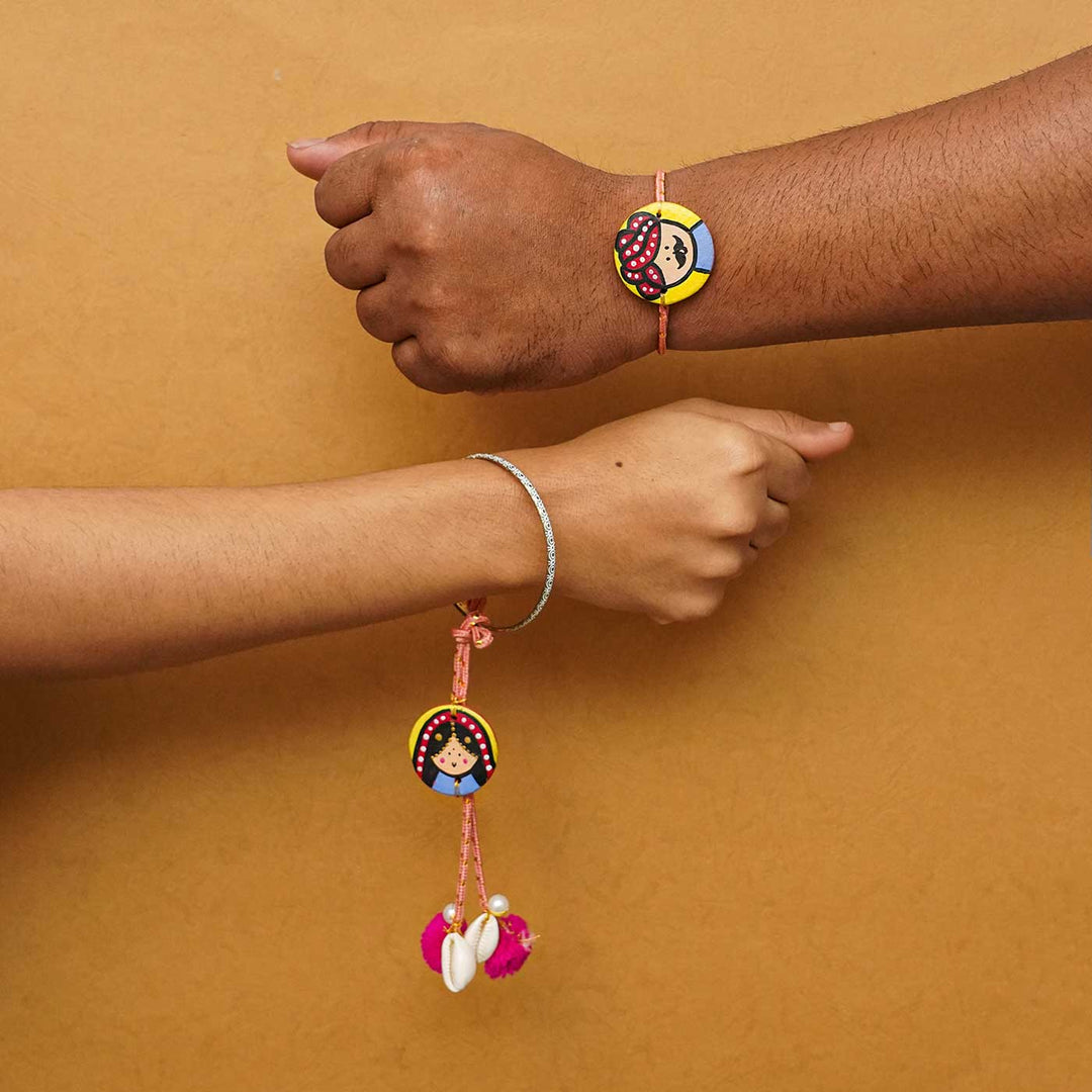 Handcrafted Raja Rani Terracotta Rakhi With Roli Chawal - Bracelets worn on wrist and hand