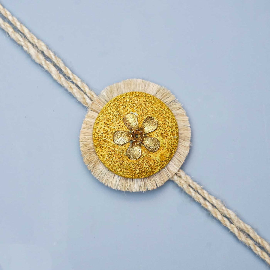 Handmade Papier Mache Gold Floral Rakhi With Roli Chawal - Close-up of Decorative Centerpiece