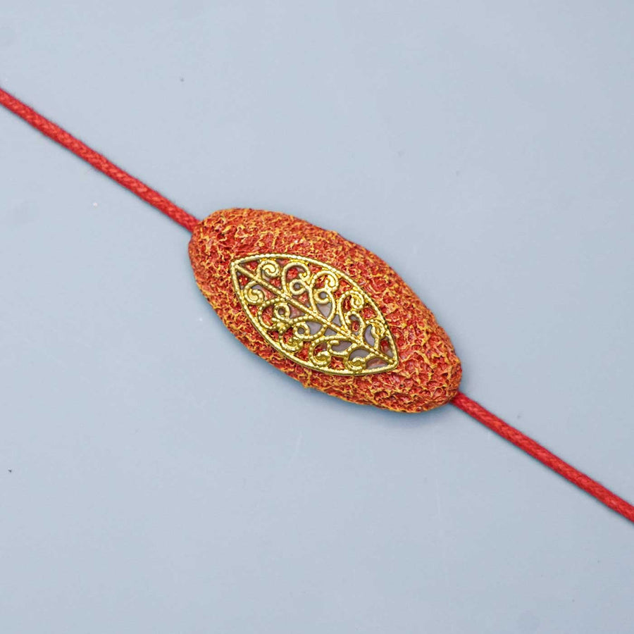 Handmade Papier Mache Naquashi Red Rakhi With Roli Chawal - Close-up of Bracelet Ornament