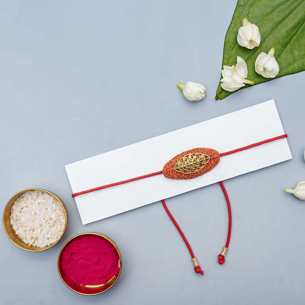 Handmade Papier Mache Naquashi Red Rakhi With Roli Chawal - Flat Lay with Traditional Items