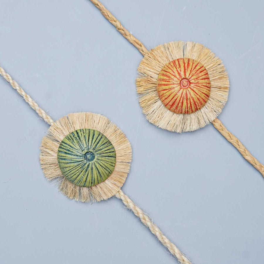 Handmade Papier Mache Rustic And Green Mushroom Rakhi With Roli Chawal Set Of 2 - Close-up of decorative braided bands