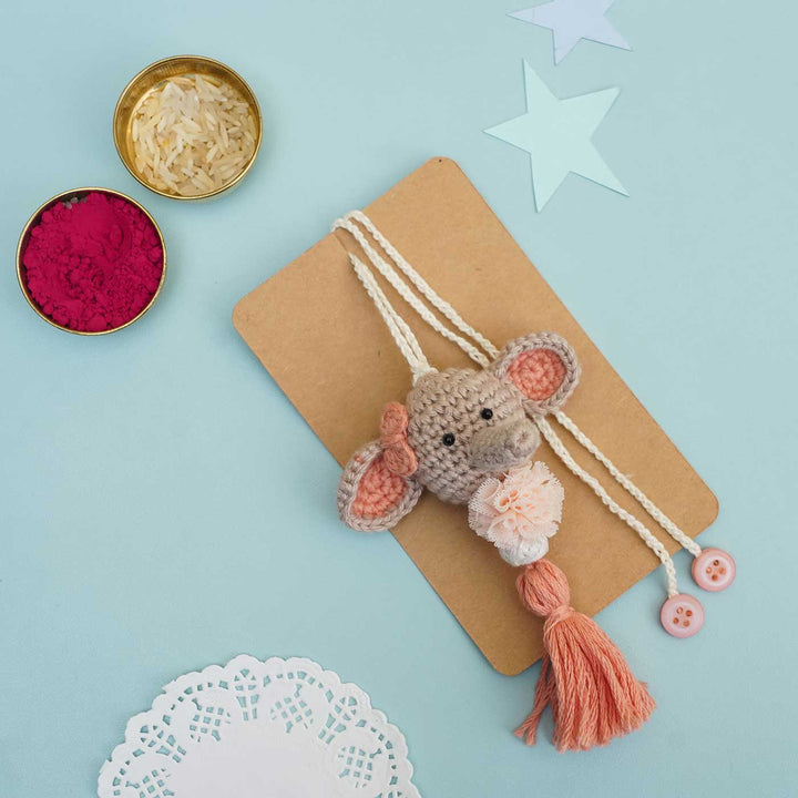 Handmade Crochet Dumbo Kids Rakhi With Roli Chawal - Flat Lay with Accessories