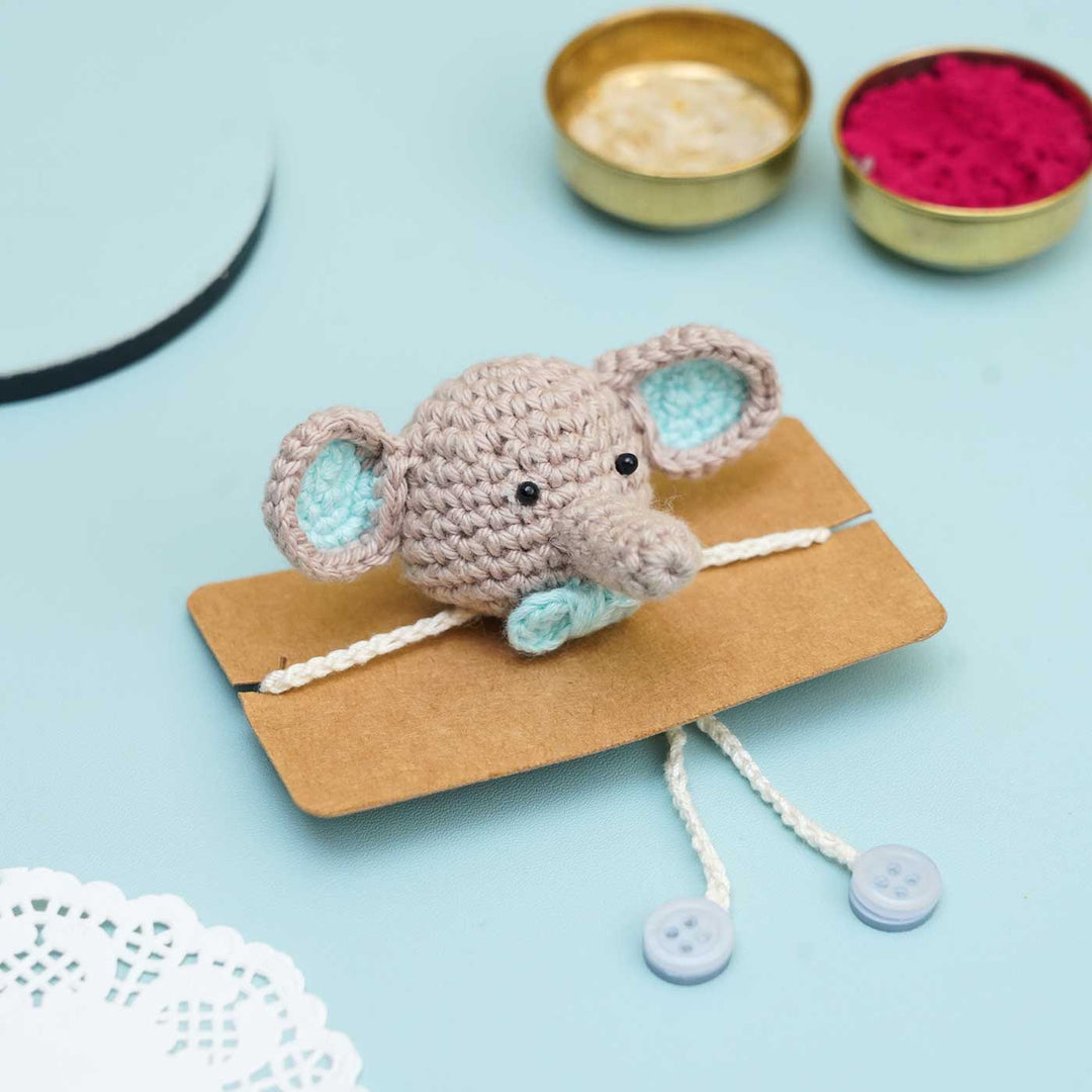 Handmade Crochet Dumbo Kids Rakhi With Roli Chawal - Packaging Display on Cardboard