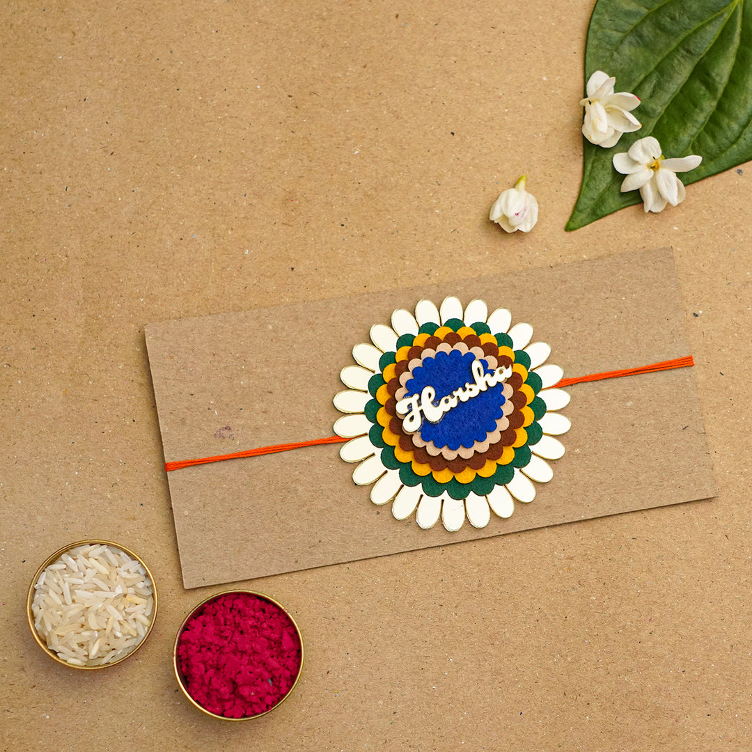 Personalized Handmade Flower Name Acrylic Rakhi With Roli Chawal - Packaged with traditional elements