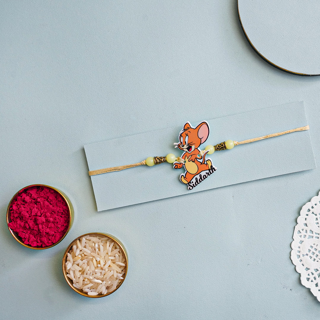 Personalized Handmade Tom And Jerry Acrylic Kids Rakhi With Roli Chawal - Flat Lay with Rakhi and Puja Items (4)