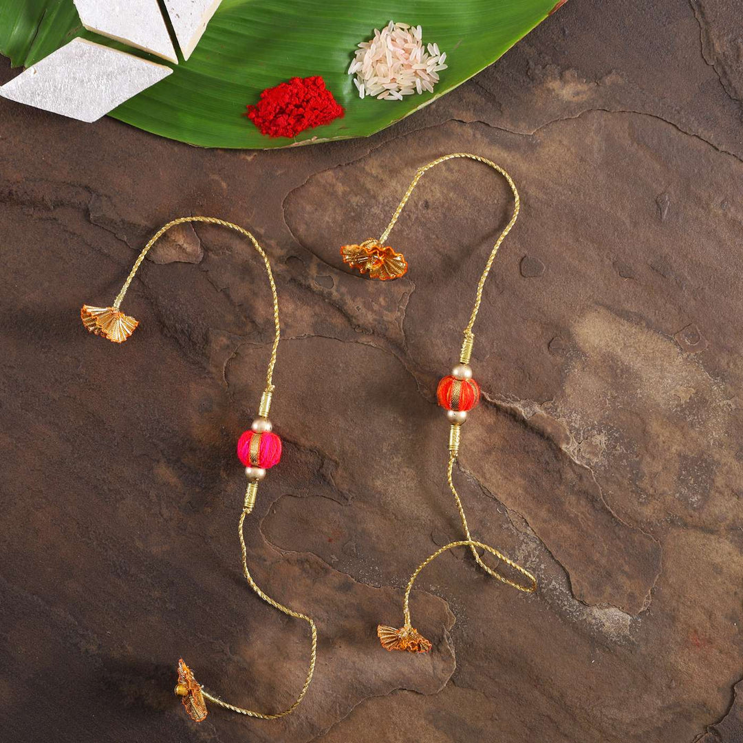 Handmade Beaded Jhilmil Gota Rakhi With Roli Chawal Set Of 2 - Flat Lay with Traditional Items
