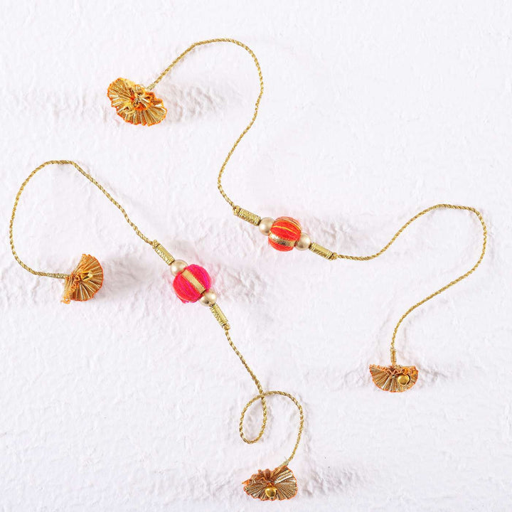 Handmade Beaded Jhilmil Gota Rakhi With Roli Chawal Set Of 2 - Flat Lay on White Surface