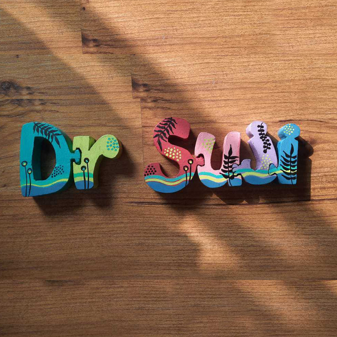 Hand Painted Wooden Jigsaw Name Blocks For Doctor - Top Angle Showing Shadow and Texture