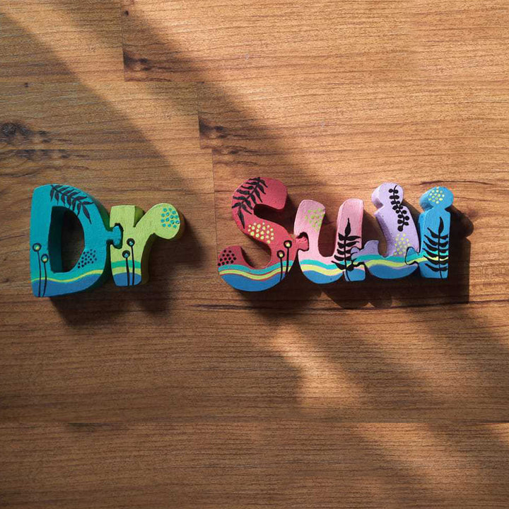 Hand Painted Wooden Jigsaw Name Blocks For Doctor - Top Angle Showing Shadow and Texture