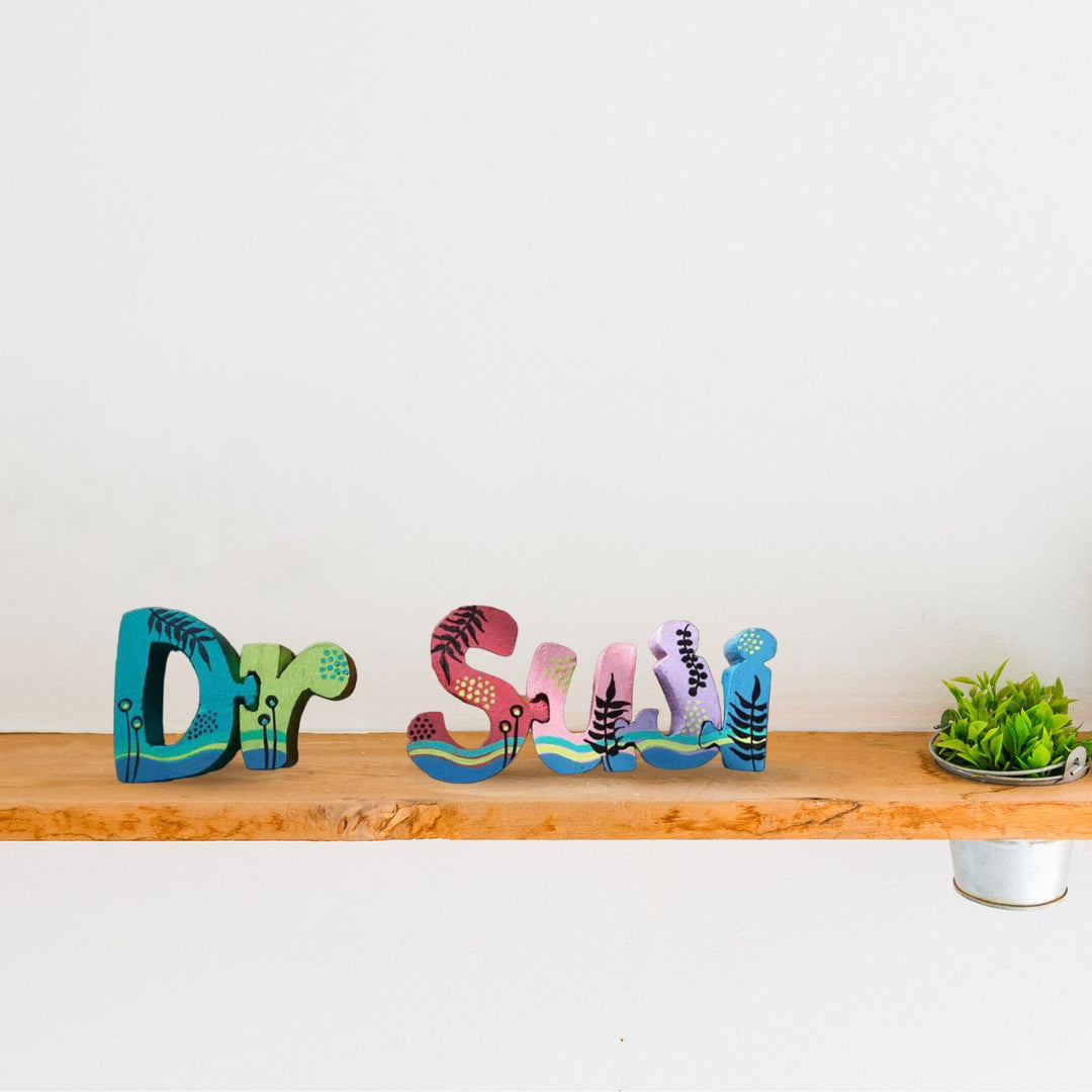 Hand Painted Wooden Jigsaw Name Blocks For Doctor - Front View on Wooden Shelf